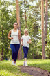© bakharev - running sporty mother and daughter. woman and child jogging in a park. outdoor sports and fitness family.