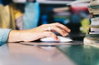© Raul Mellado - closeup of a female hand clicking computer mouse
