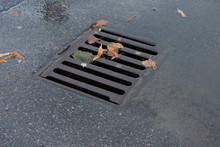 Old Storm Drain Or Storm Sewer On The Road In Rainy Day