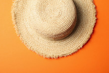 Straw Hat On Orange Background, Top View