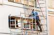 © kpn1968 - Working plasterer working on the scaffolding at the wall