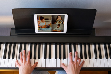woman having video chat with friends and playing music