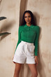 © indiraswork - Brunette woman beautiful sexy face cosmetic tanned skin makeup wear white cotton short green top fashion clothes style collection accessory bag interior summer art armchair plant furniture.