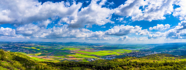 Wall Mural - panorama of valley, green fields, pastures, clouds 