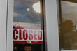 © Chelsea Victoria/Stocksy - A closed sign on a shop window
