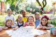 © Halfpoint - Kids birthday party outdoors in garden in summer, celebration concept.