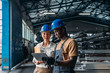 © Studio Firma/Stocksy - Worker talking with businesswoman in factory