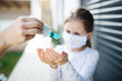 © Halfpoint - Small girl with face mask outdoors at home. Corona virus and quarantine concept.