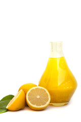 Wall Mural - Lemon juice in a glass jug, lemons on an empty white background.