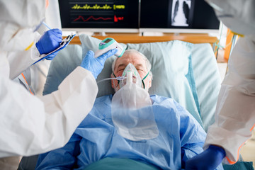 Wall Mural - Infected patient in quarantine lying in bed in hospital, coronavirus concept.