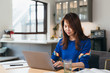 © MaaHoo Studio/Stocksy - Young Asian woman working with computer at home