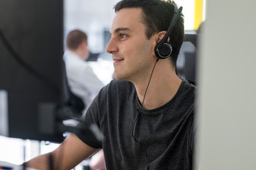 Young male developer working in the office