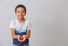 Little African-American Boy With Red Heart On Grey Background. Concept Of Donations