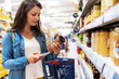 © Santi Nunez/Stocksy - Beautiful woman buying food in a supermarket