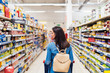 © Santi Nunez/Stocksy - Back view of Beautiful woman buying food in a supermarket