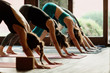© Javier Pardina/Stocksy - Scene of a group of people practicing yoga in class.