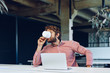 © fotofabrika - Portrait of young caucasian businessman using laptop computer at his workplace in modern office
