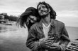 © Yura Shevchenko/Stocksy - young couple embracing on the sea shore