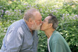 © Joselito Briones/Stocksy - Senior Gay Couple Kissing in a Park