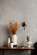 © Alina Hvostikova/Stocksy - Decorations on small table in stylish room