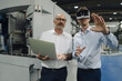© Westend61 - Two men with VR glasses in factory