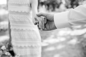 the bride and groom tenderly hold hands between them love and relationships