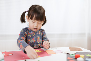 Wall Mural - toddler girl  making craft for homeschooling