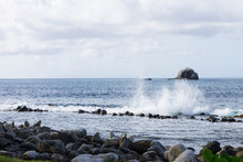 Splashing Water And Wave Crashing Rocks With Beautiful Coastal Scenery