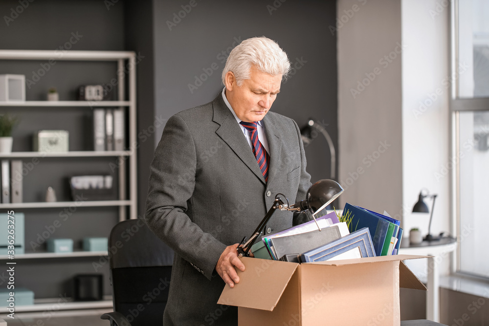 Sad fired mature man in office
