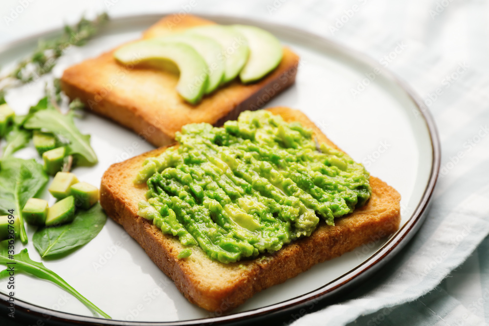 Tasty avocado sandwiches on plate