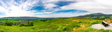 Fototapeta Storczyk - Panoramic view with a park bench overlooking Camino Tassajara on the slope of a hill in Sycamore Valley Preserve Contra Costa County Danville, California.