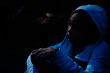 © Inti St. Clair - Sad girl in hoodie sitting in the dark with face lit by moonlight