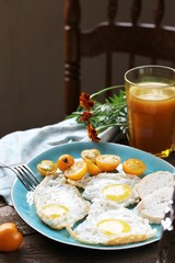 Sticker - sunny breakfast life style, fried eggs and yellow cherry tomatoes. on a blue plate. yellow and blue