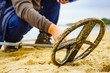 © Voyagerix - Man with metal detector on sea beach