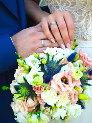 Wall Mural - Hands of the newlyweds with rings, wedding bouquet. Russia. Russian tradition. Ural