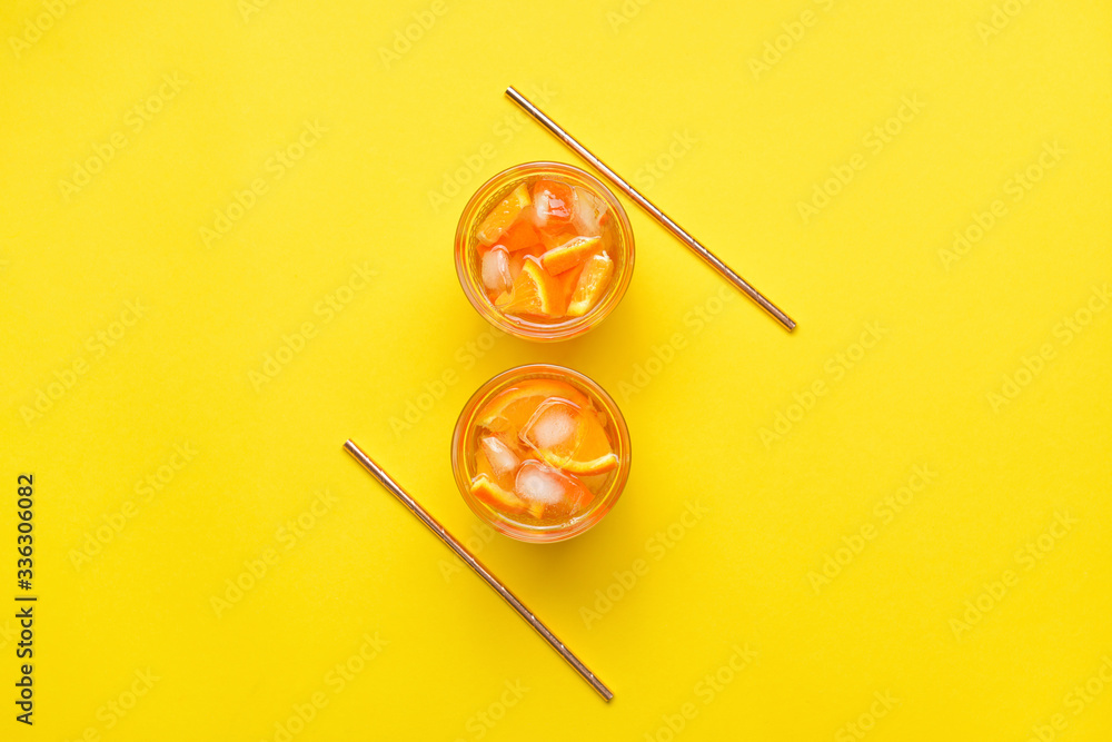 Glasses of tasty cold ice tea on color background