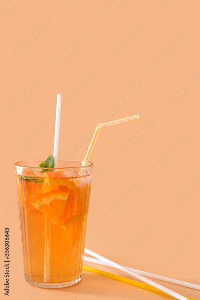 Glass of tasty cold ice tea on color background