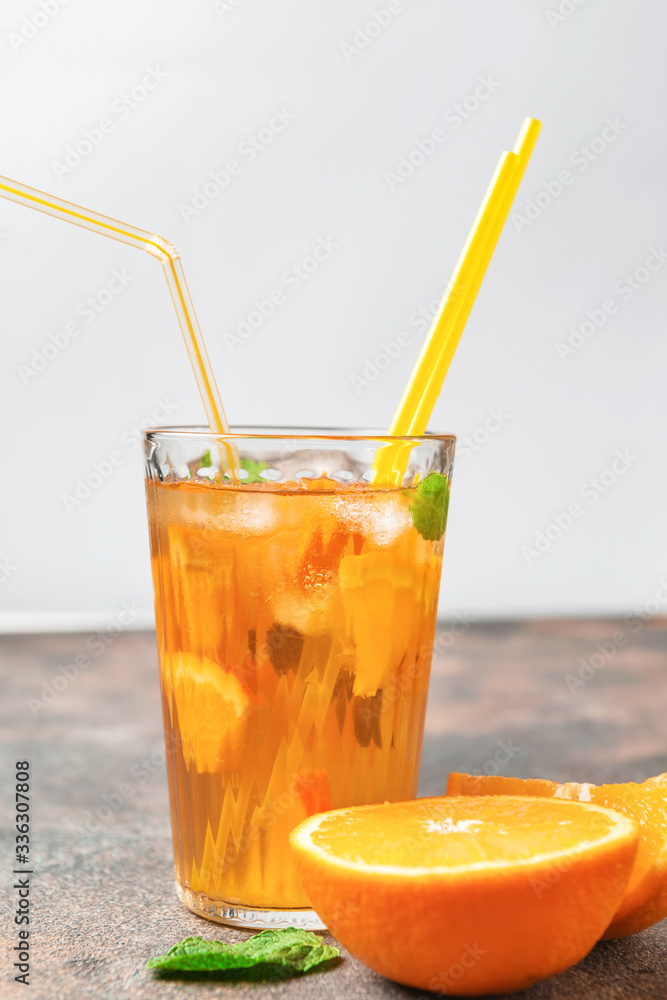 Glass of tasty cold ice tea on table