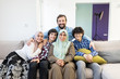© Jasmin Merdan - Happy Muslim family portrait on sofa