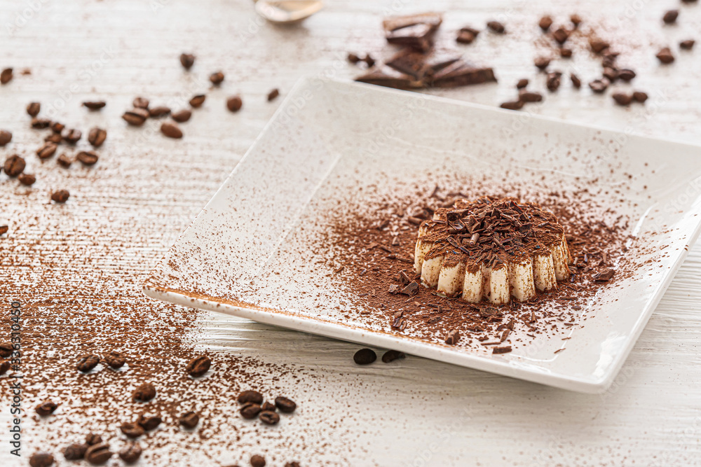 Plate with tasty panna cotta on table