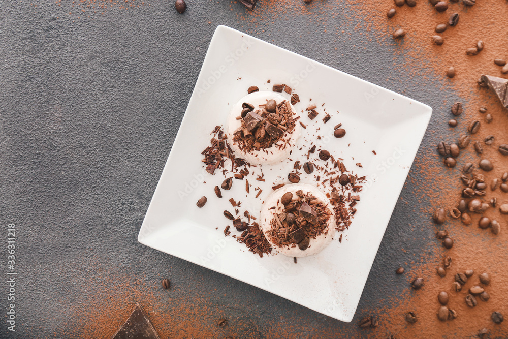 Plate with tasty panna cotta on dark background