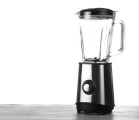 Modern blender on table against white background