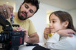 © Jasmin Merdan - Dad and son at home sitting and fixing camera