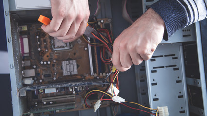 Wall Mural - Repairman trying to repair computer. Repair, Service