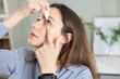 © dragonstock - Closeup view of young woman applying eye drop