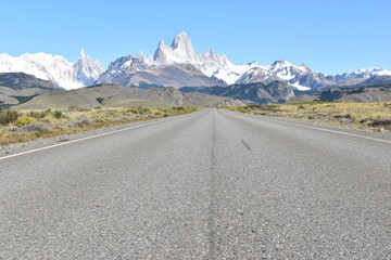 Wall Mural - Street to Glacier National Park in El Chalten, Argentina, Patagonia with snow covered Fitz Roy Mountain in background