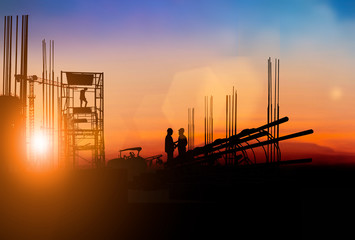 Wall Mural - Silhouette Engineer and construction team working at site over blurred  industry background with Light fair Film Grain effect.Create from multiple reference images together