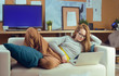 © MoreThanProd - Girl lying on a sofa looking at a laptop. The girl lies on the devan and watches TV shows, videos, procrastination.