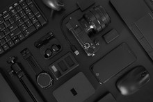 Flat Lay Of Black Office Desk Table With Many Black Gadgets