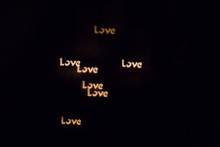 Colorful Love Lettering Bokeh On A Dark Background, Yellow Love Lettering Bokeh